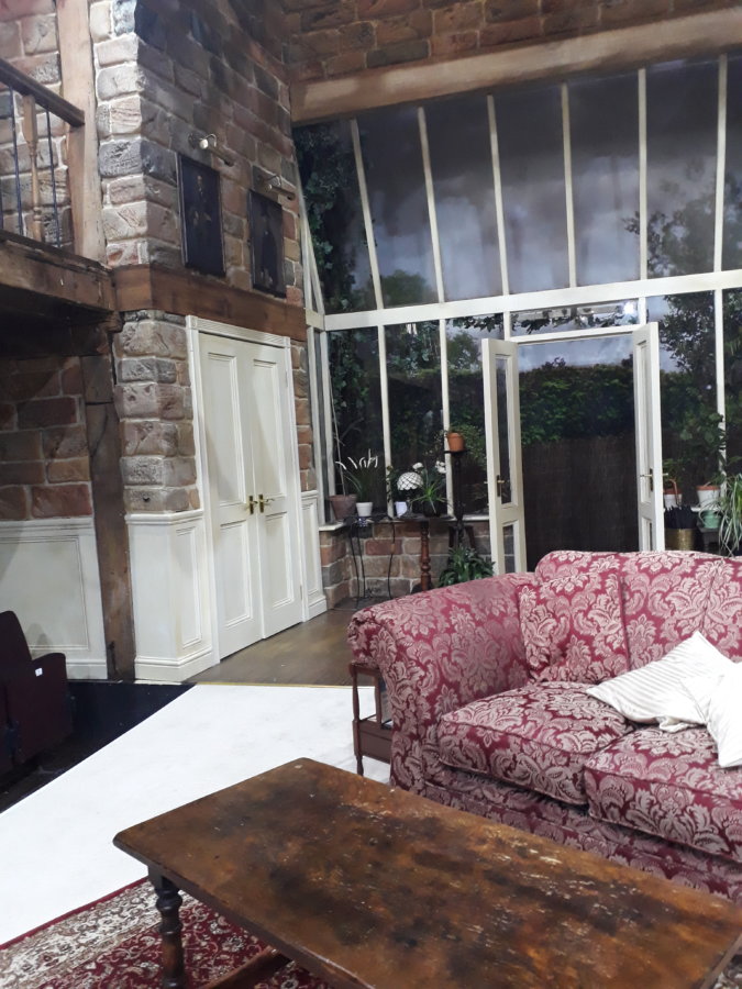 House set, dressed and under working lights designed by Neil Irish at The Watermill Theatre